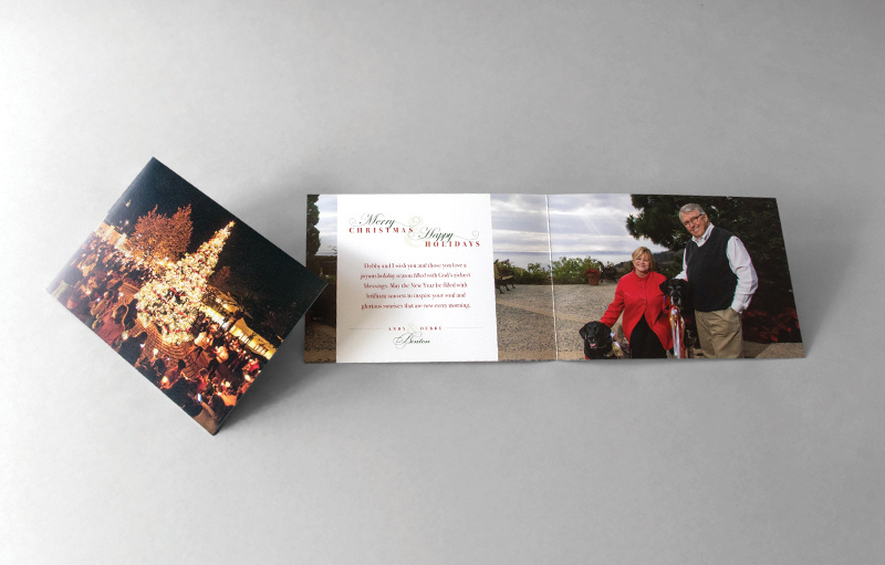 A holiday card of a couple with their dog