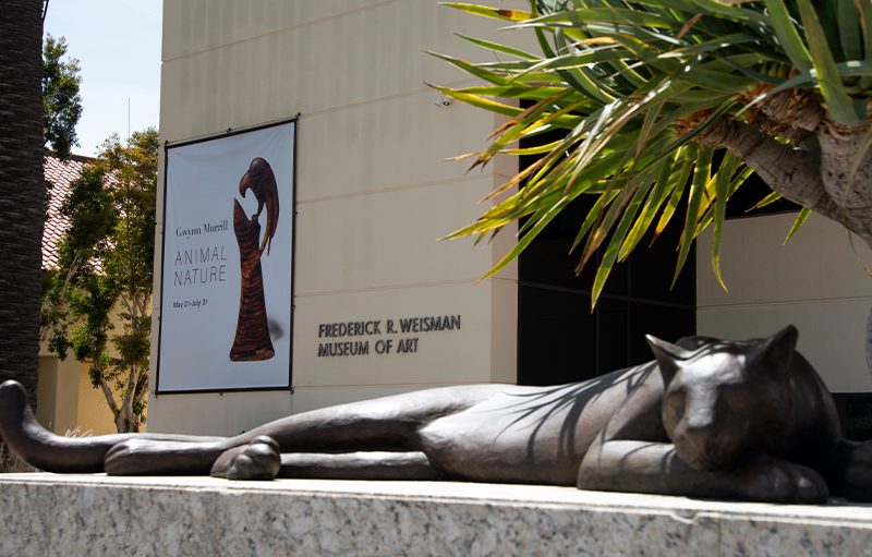 Weisman Museum building banner with sculpture in the foreground that matches the banner